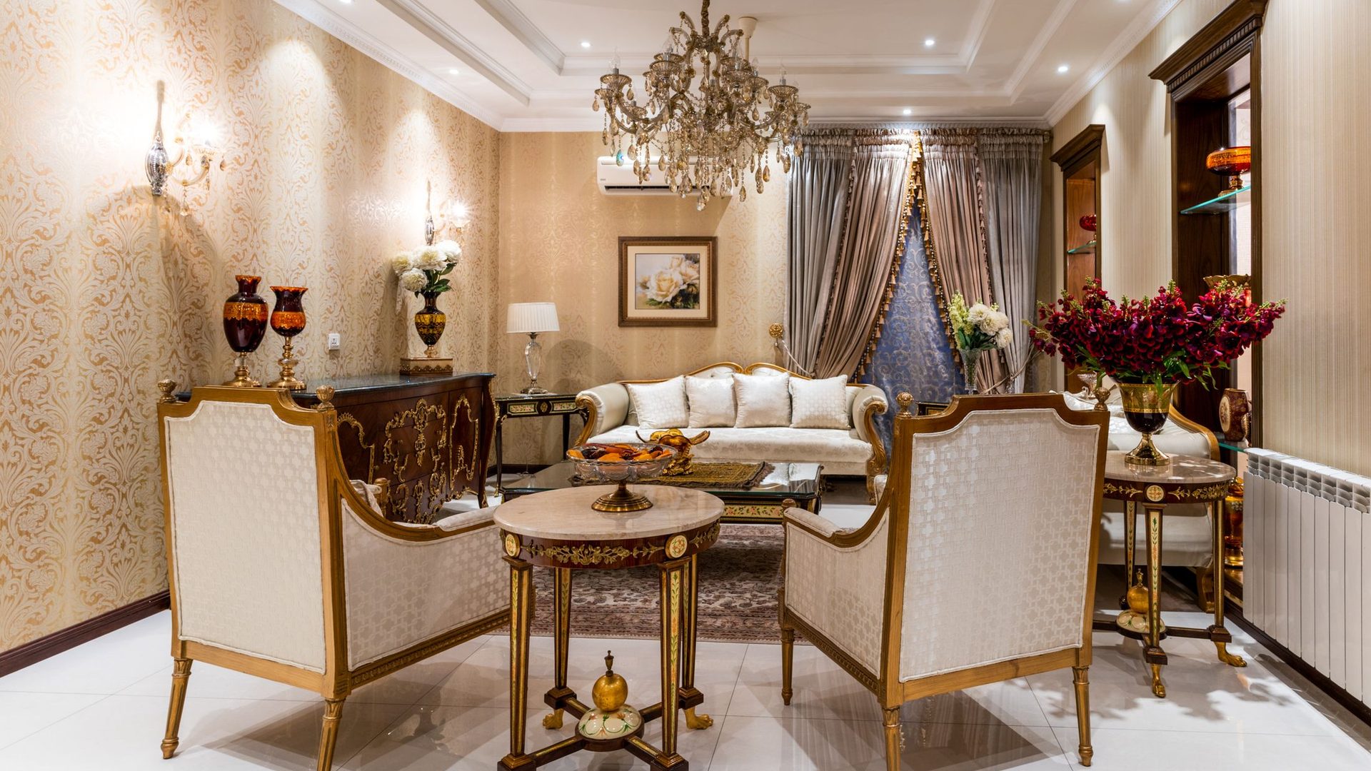 Elegant living room with damask wallpaper, chandelier, and refined furnishings